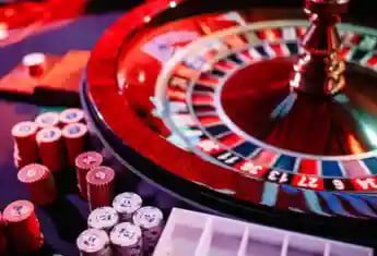 Mobile app interface showing live casino lobby with dealer video streams